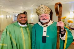 Fr Agbaw-Ebai with Cardinal Sean O’Malley The Present Continuous Tense of Palm Sunday