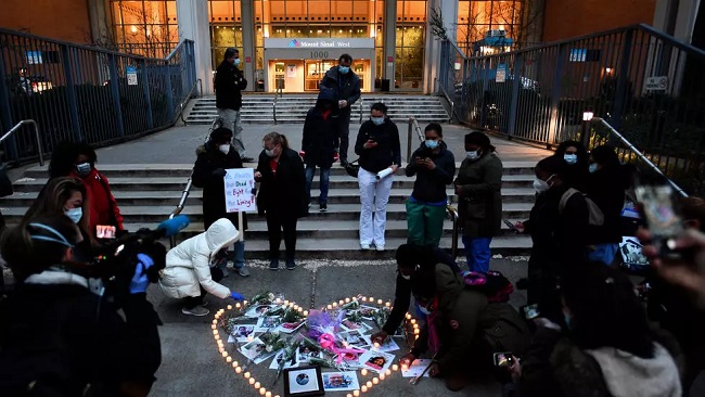 New York health workers hold vigil for colleagues who died in virus fight