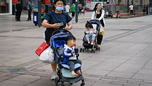 China allows couples to have up to three children